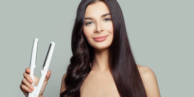 Image shows how a girl with her Hair Straightener